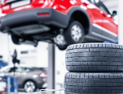 car up in the air with its wheels on the ground